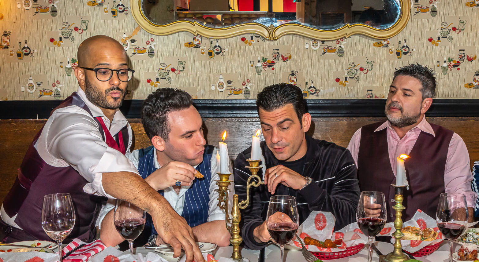 four men eating at an italian restaurant